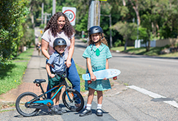 Mother and children crossing the road to school